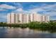 Waterfront condominium complex with multiple balconies overlooking lush greenery and tranquil waters, creating a serene retreat at 4516 Seagull Dr # 615, New Port Richey, FL 34652