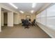 A spacious conference room features a round table, rolling chairs, and natural light from a large window at 4516 Seagull Dr # 615, New Port Richey, FL 34652