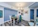 Stylishly furnished dining room showcases a light fixture, a blue accent wall, and eye-catching furniture at 4516 Seagull Dr # 615, New Port Richey, FL 34652