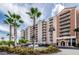 Beautiful exterior of the building with a circular driveway and palm tree landscaping at 4516 Seagull Dr # 615, New Port Richey, FL 34652