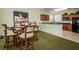 This game room features a wine bar, a round table with barstool seating and a print of a wine-themed painting at 4516 Seagull Dr # 615, New Port Richey, FL 34652