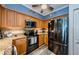 Updated kitchen showcasing stainless steel appliances, wood cabinets, granite countertops, and modern finishes at 4516 Seagull Dr # 615, New Port Richey, FL 34652
