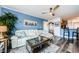 Cozy living room with a comfortable sofa, artwork, and a peek into the kitchen at 4516 Seagull Dr # 615, New Port Richey, FL 34652