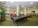 This lounge features many sofas, chairs, greenery, and a pool table with cover in a large, well-lit space at 4516 Seagull Dr # 615, New Port Richey, FL 34652