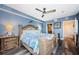 This serene main bedroom offers a decorative wood bed frame, wood flooring, and a ceiling fan for added comfort at 4516 Seagull Dr # 615, New Port Richey, FL 34652