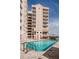 Exterior of building showcasing a sparkling pool with lounge chairs, perfect for relaxation at 4516 Seagull Dr # 615, New Port Richey, FL 34652