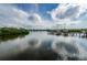 Picturesque waterfront view with private boat docks and sailboats, surrounded by lush greenery and serene waters at 4516 Seagull Dr # 615, New Port Richey, FL 34652