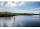 Peaceful waterfront view featuring lush green mangroves and calm blue waters, with navigational markers in place at 4516 Seagull Dr # 615, New Port Richey, FL 34652