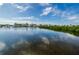Expansive waterfront view with a tranquil body of water, lush mangroves, and elegant homes in the distance at 4516 Seagull Dr # 615, New Port Richey, FL 34652
