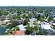 A neighborhood with lush green trees and beautiful single-Gathering homes with tile roofs at 5110 W Poe Ave, Tampa, FL 33629