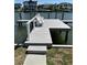 Well-maintained wooden dock offers seating with views of the serene canal and waterfront residences at 5110 W Poe Ave, Tampa, FL 33629