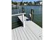 Dock featuring a hose and ladder, with a beautiful waterfront view, and residences across the canal at 5110 W Poe Ave, Tampa, FL 33629