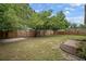 Spacious backyard with mature trees, a wooden fence, and a grass lawn for outdoor activities and enjoyment at 5115 32Nd N Ave, St Petersburg, FL 33710