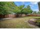 Expansive backyard featuring lush lawn, mature trees, concrete patio, and wooden perimeter fencing at 5115 32Nd N Ave, St Petersburg, FL 33710