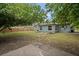 Fully-fenced backyard with mature trees and grassy lawn, provides privacy and plenty of room for outdoor enjoyment at 5115 32Nd N Ave, St Petersburg, FL 33710