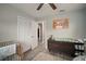 Bedroom room features a crib, changing table, and closet with hardwood floors at 5115 32Nd N Ave, St Petersburg, FL 33710