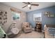 Charming Bedroom room featuring a crib, rocker, shelves, and natural light from two windows at 5115 32Nd N Ave, St Petersburg, FL 33710