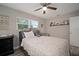 Bedroom featuring a comfortable bed, dresser, and shelves with photos and decorations, with lots of light at 5115 32Nd N Ave, St Petersburg, FL 33710