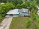Beautiful single-story home with blue door and lush green landscaped front yard at 5115 32Nd N Ave, St Petersburg, FL 33710