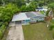 Charming single-story home featuring a carport, blue door, and landscaped front yard at 5115 32Nd N Ave, St Petersburg, FL 33710