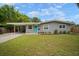 Inviting exterior with well-manicured lawn, carport, and bright, colorful door adding a pop of charm to the home at 5115 32Nd N Ave, St Petersburg, FL 33710