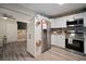 Charming kitchen with stainless appliances, ample cabinet space, and stylish light gray wood flooring at 5115 32Nd N Ave, St Petersburg, FL 33710