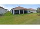 Wide backyard view with screen enclosed lanai at 5313 Windy Grove Dr, Wimauma, FL 33598