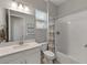 Well-lit bathroom featuring a vanity with white marble countertop and shower-tub combination at 5313 Windy Grove Dr, Wimauma, FL 33598