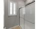 Modern bathroom features a glass-enclosed shower and a light gray wall at 5313 Windy Grove Dr, Wimauma, FL 33598