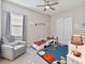 Fun bedroom with car bed, ceiling fan, sport themed rug, and a comfortable gray chair at 5313 Windy Grove Dr, Wimauma, FL 33598