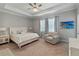 Serene bedroom with tray ceilings, comfortable furnishings, soothing color palette, and lots of natural light at 5313 Windy Grove Dr, Wimauma, FL 33598