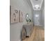 Elegant hallway with a console table, decorative mirror, and a chandelier at 5313 Windy Grove Dr, Wimauma, FL 33598