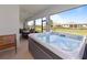 Relax in this luxurious hot tub with serene views of the backyard and community in this covered outdoor space at 5313 Windy Grove Dr, Wimauma, FL 33598