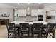 Bright kitchen featuring a large center island with seating, white cabinets, stainless appliances and a gas cooktop at 5313 Windy Grove Dr, Wimauma, FL 33598