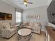 Cozy living room featuring a comfortable sofa, accent chair, and tasteful decor at 5313 Windy Grove Dr, Wimauma, FL 33598