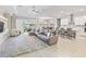 Expansive living space with tile flooring, modern furnishings, and seamless indoor-outdoor flow at 5313 Windy Grove Dr, Wimauma, FL 33598