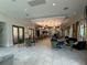 The lounge features wood look tile floors, neutral walls, and a bar at 5313 Windy Grove Dr, Wimauma, FL 33598