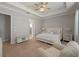 Serene main bedroom with a tray ceiling, neutral color palette, and an en-suite bathroom at 5313 Windy Grove Dr, Wimauma, FL 33598
