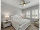 Bright main bedroom with white furniture, ceiling fan, and soothing decor for a tranquil retreat at 5313 Windy Grove Dr, Wimauma, FL 33598