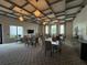 Large meeting room with tables, chairs, modern light fixtures and carpeted floor at 5313 Windy Grove Dr, Wimauma, FL 33598