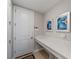 Mud room features long countertop with artwork on the walls and coat hangers at 5313 Windy Grove Dr, Wimauma, FL 33598