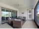 Relax in this screened patio area featuring comfortable seating and stylish decor at 5313 Windy Grove Dr, Wimauma, FL 33598