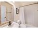Clean bathroom with a shower-tub combination, framed mirror, and neutral color scheme at 5403 Avenal Dr, Lutz, FL 33558