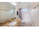 Clean bathroom with granite countertop vanity, tiled floor, and tub with shower at 5403 Avenal Dr, Lutz, FL 33558