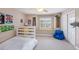 Cozy bedroom with large window, built-in shelves, and soft carpet at 5403 Avenal Dr, Lutz, FL 33558