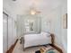 Cozy bedroom features a ceiling fan, light-colored walls, and hardwood floors at 5403 Avenal Dr, Lutz, FL 33558