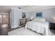 Comfortable bedroom with a ceiling fan, light-colored walls, and a cozy area rug at 5403 Avenal Dr, Lutz, FL 33558