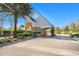 Picturesque community entrance with brick paved drive and lush landscaping at 5403 Avenal Dr, Lutz, FL 33558