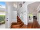 Inviting foyer with hardwood floors, elegant staircase, and ample natural light at 5403 Avenal Dr, Lutz, FL 33558