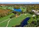 Aerial view showcasing the lush green golf course with water features and surrounding landscape at 5403 Avenal Dr, Lutz, FL 33558